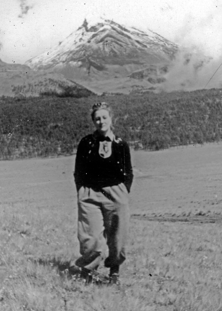 Esperanza Lopez Mateos in a meadow in front of Mt. Popo